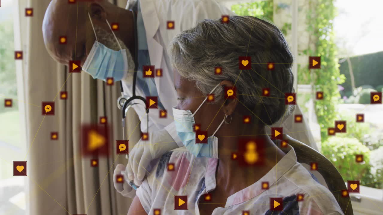 Animation of network of connections with icons over senior african american woman and male doctor
