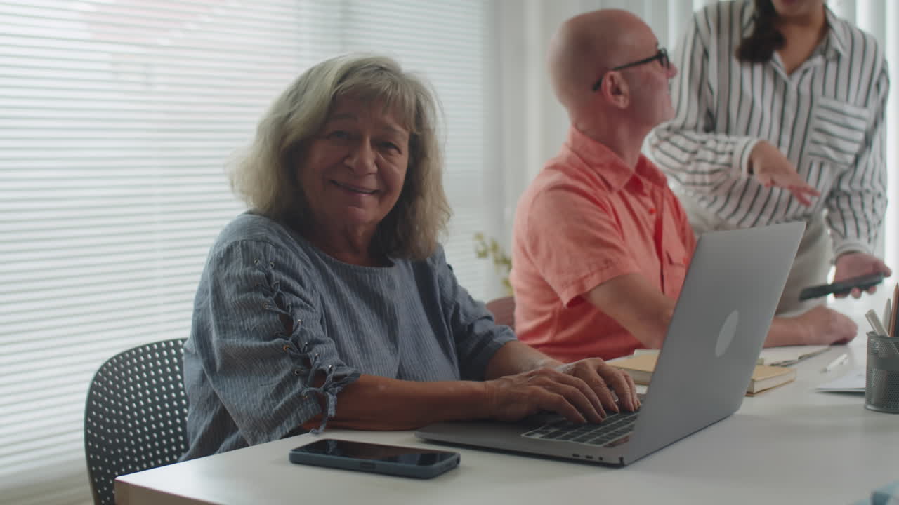 Portrait of Mature Woman Learning to Use Laptop