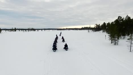snowmobile tour in a snowy landscape