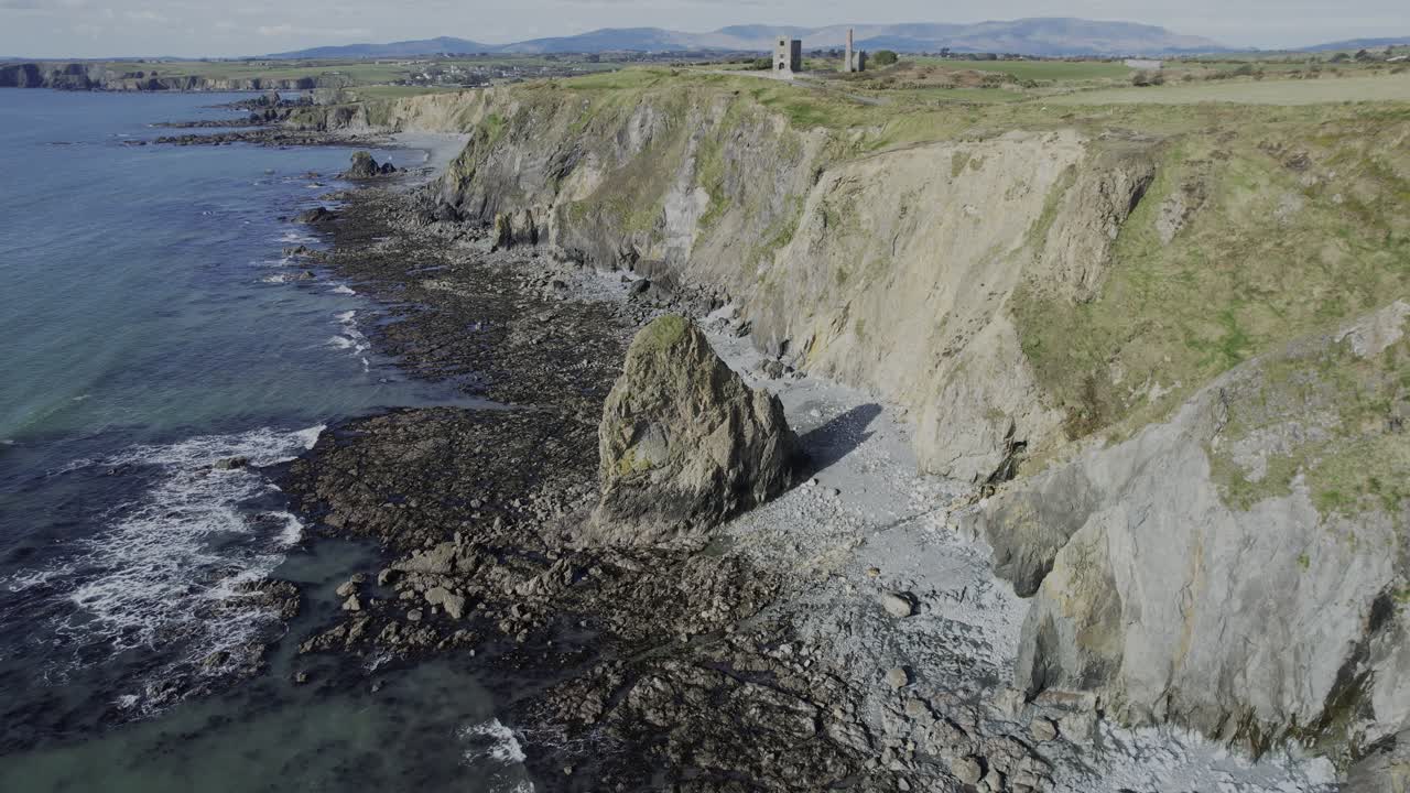 Irish coastal landscapes low tide at Copper Coast Waterford seastack and industrial building ruins