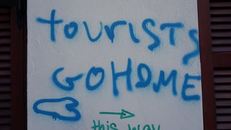 graffiti message: tourists go home