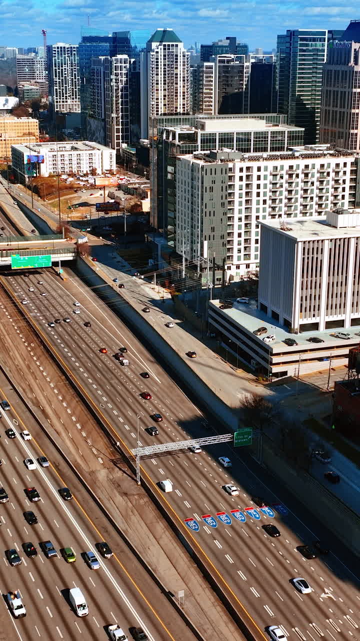 Flight above the highways with busy traffic. Top view on the downtown of Atlanta, Georgia, USA on sunny autumn day. Vertical video