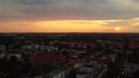 paulsen gymnasium high school at orange mystique sunset
magic aerial view flight fly backwards drone
of berlin steglitz germany at summer day august 2022