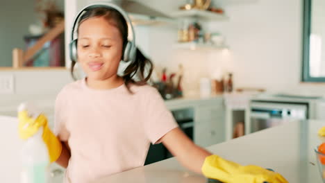 girl child, headphones and spray for cleaning