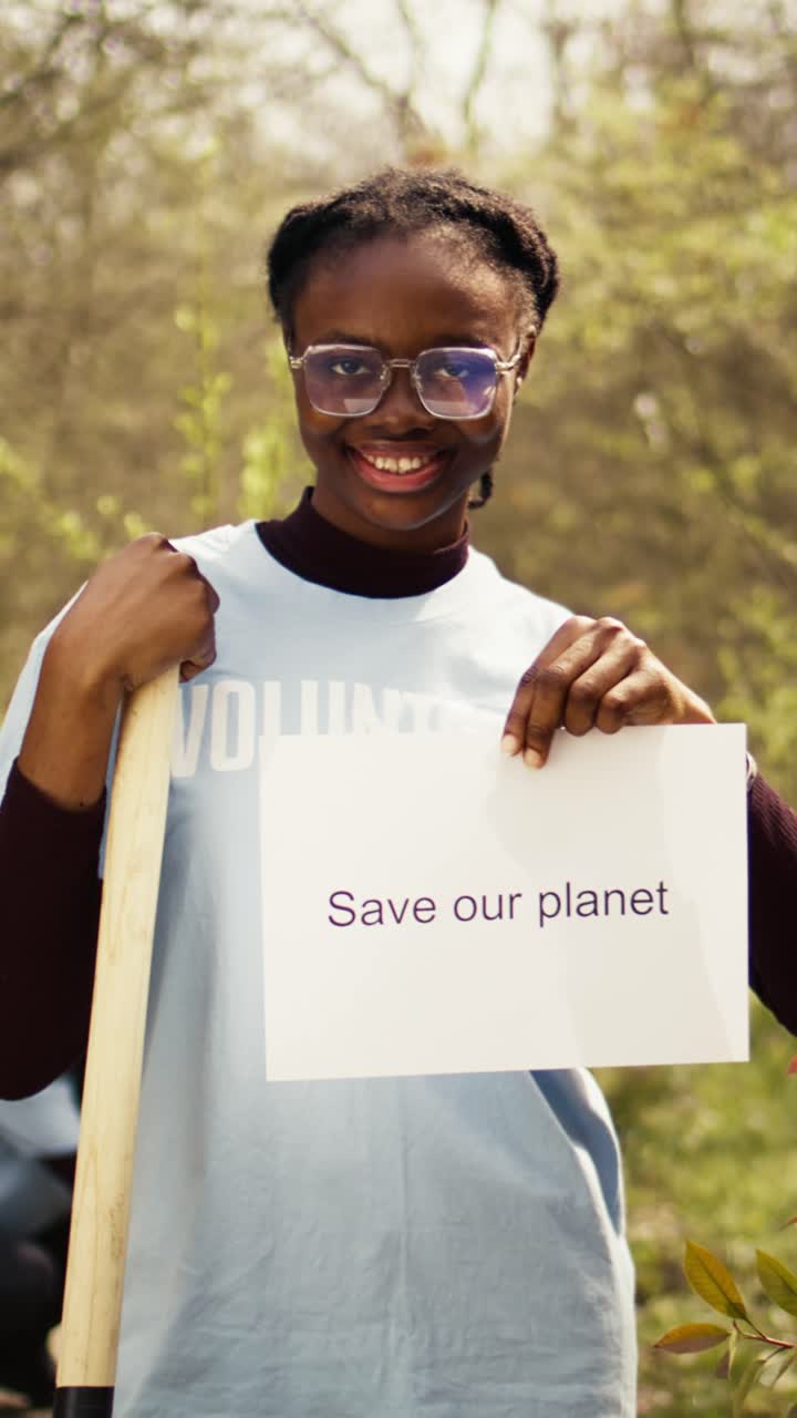 Smiling African American Woman Volunteer Holding 'Save Our Planet' Sign