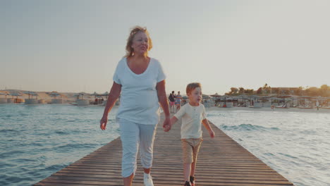 Grandmother-and-grandson-having-outdoor-walk-on-resort