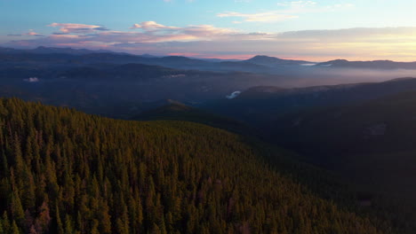 cinematic aerial drone sunrise morning sun flare denver front range foothills rocky mountains layers i70 idaho springs evergreen mount evans 14er wilderness squaw pass echo mountain circling right