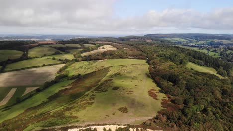 aerial view of english scenic hill with trees in devon