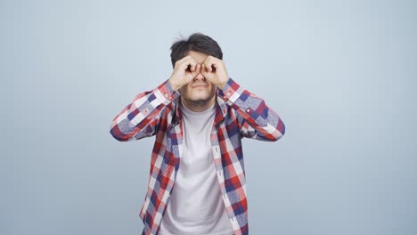 man with binoculars looking away.