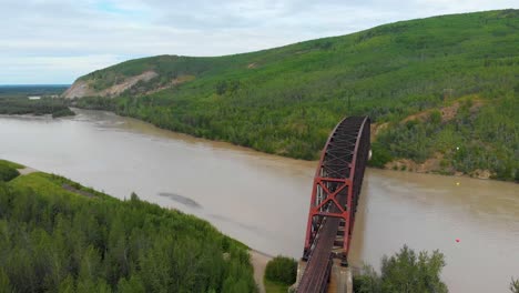 4K-Drone-Video-of-Mears-Memorial-Steel-Truss-Train-Bridge-over-the-Tanana-River-at-Nenana,-Alaska-during-Summer-Day