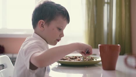 child in school uniforms breakfasts before going to school 1