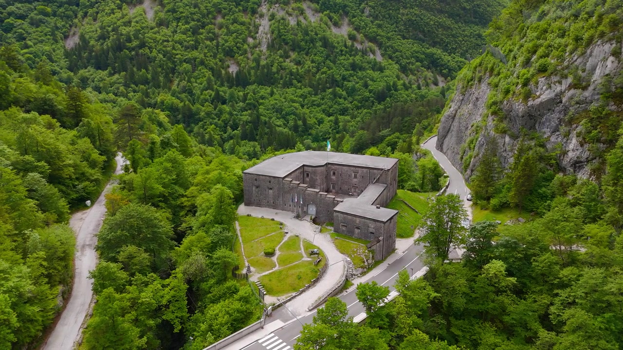 Drohnenaufnahme des historischen Fort Kluze im Alpental nahe Bovec, Slowenien, kreisende Luftaufnahme als Hintergrund
