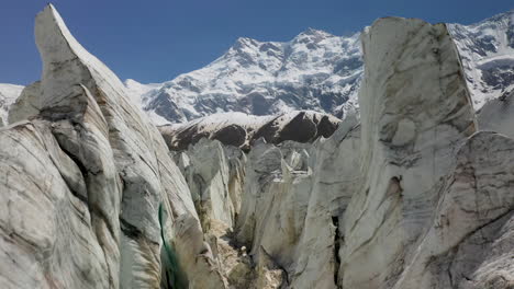 Aerial-shot-of-flying-through-the-glacier-walls-with-Nanga-Parbat-in-the-background,-Fairy-Meadows-Pakistan,-cinematic-drone-shot