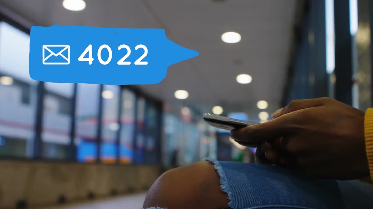 Person waiting sitting at a terminal while checking messages on social media