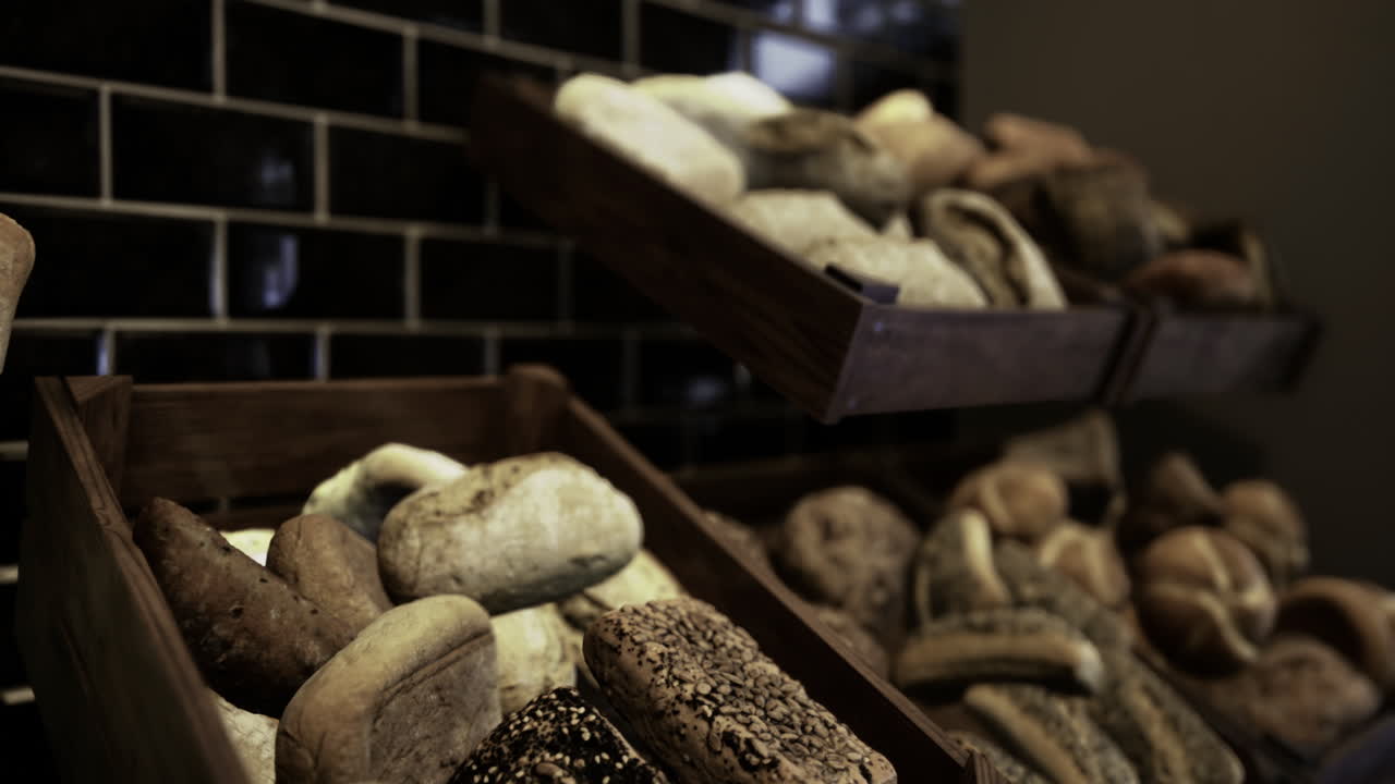 Variety of fresh baked bread displayed in a rustic bakery setting