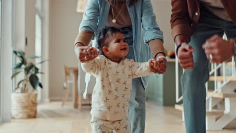 baby learning to walk with family support