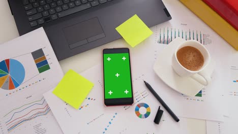 business office desk with green screen smartphone