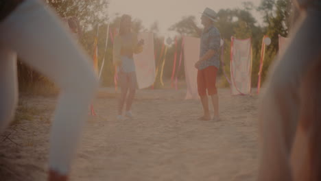 friends dancing together while grooving at beach