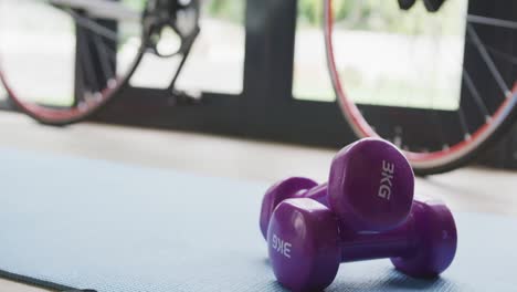 video of weights, mat and bike standing at home