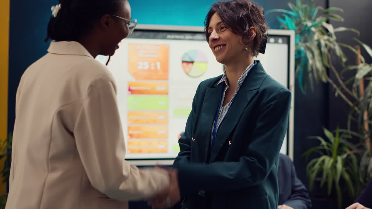 Business women shaking hands after signing a new partnership contract