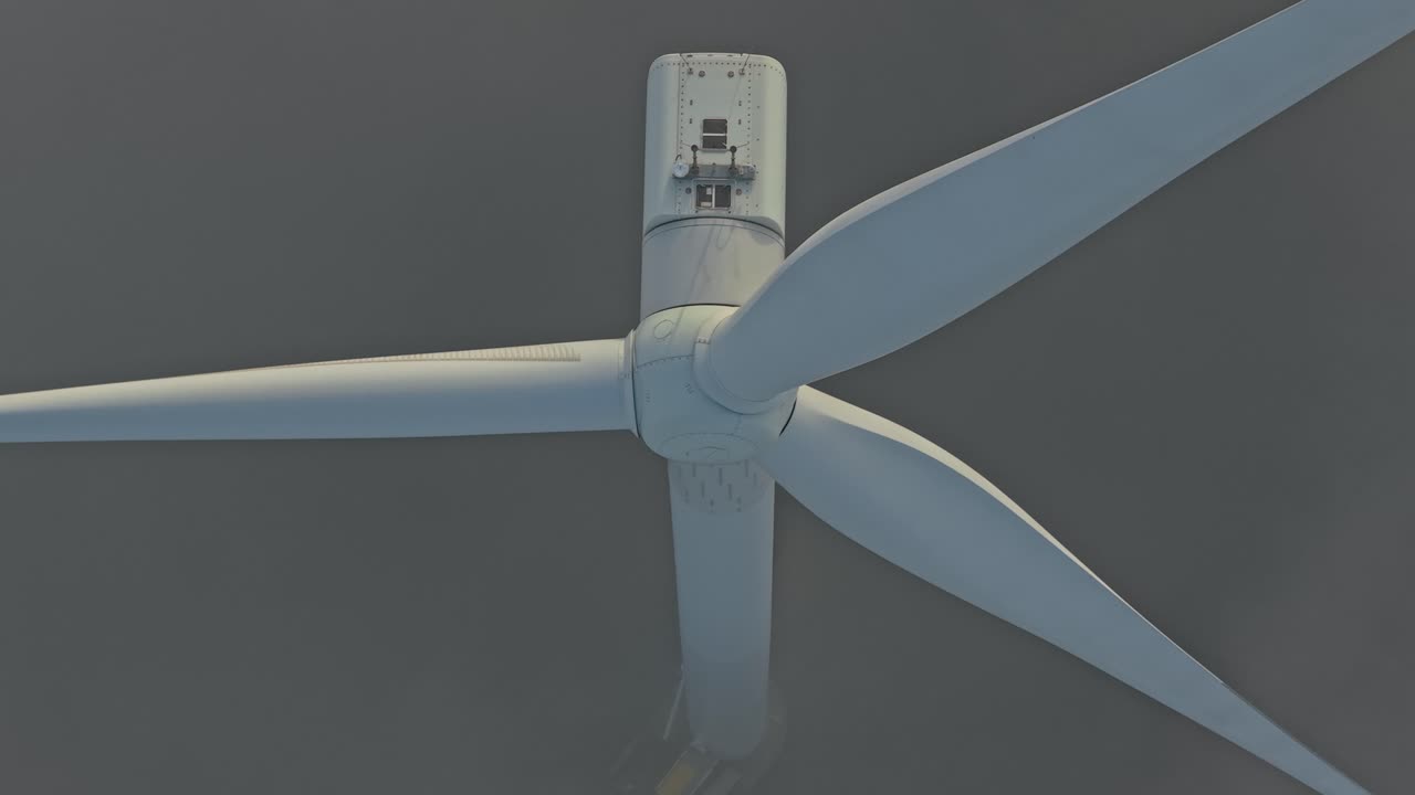 Offshore wind turbine rotating in foggy weather