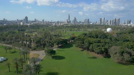 tel aviv cityscape on a sunny day. israel, aerial flying forward over park yarkon