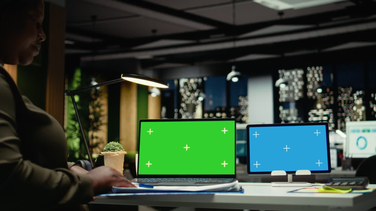 Green screen and blue screen on two devices next to entrepreneur