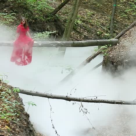 vrouw in het bos in een wolk van rook.