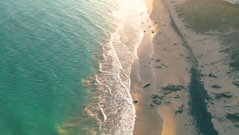 amazing sunset with spectacular dramatic purple color sky reflecting into the water pools and the neat sand surface on the secluded canary islands, spain