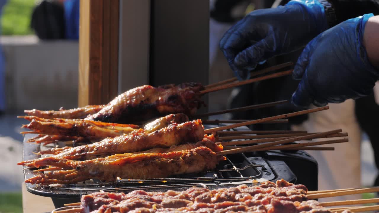 Pork meat skewer on fire, Mutton barbecue close-up. Fried meat for kebab. Cooking grilled meat beef chicken lamb BBQ . Kebab on grill. Chinese street local market with traditional food. Asian fast food.