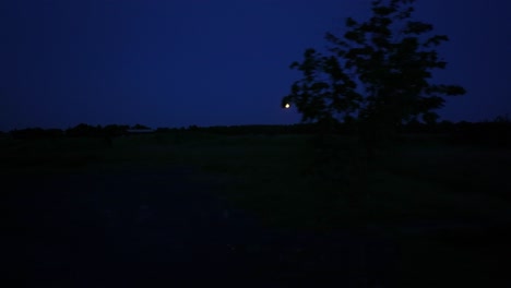 full moon over rural zeeland tracking shot