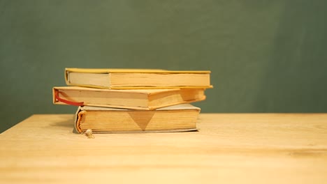 stack of old books on a wooden table