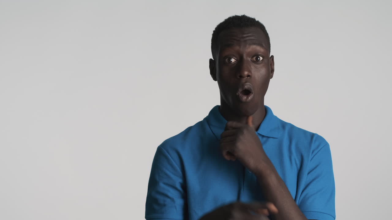 Thoughtful African american man on grey background.
