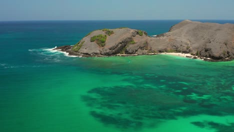 the white sand beach of tanjung aan in lombok, indonesia during a sunny day