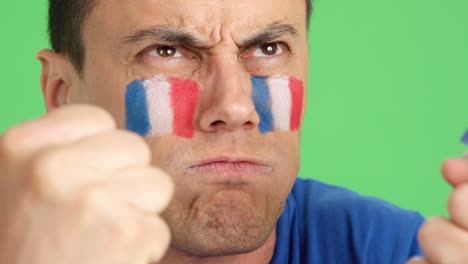 man with french national flag upset with a referee