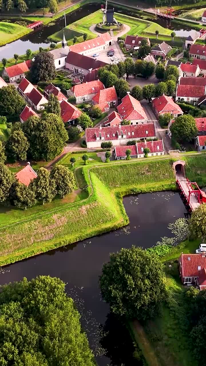 Aerial View of a Historic European Village with Red Roofs and Moat