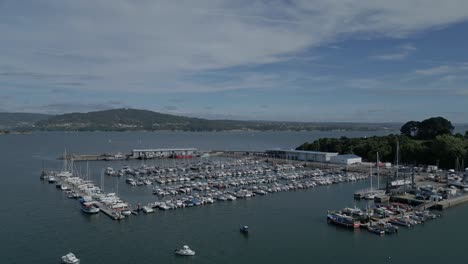 Aerial-circling-boats-moored-at-Ria-de-Ares-Nautical-Club,-Spain