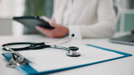 doctor with stethoscope and clipboard in clinic