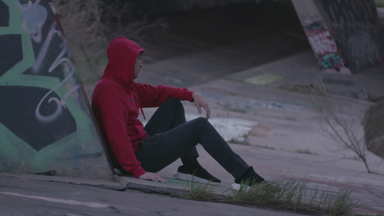Women in white crop top. Man in sweater. Urban wear under highway by city river.