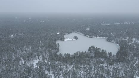 thick fog over frozen lake and snowy forest in new jersey at winter