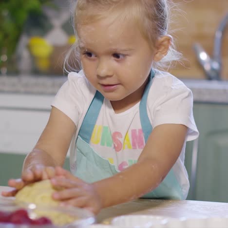 little girl having fun kneading the pastry