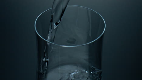 pure liquid pouring glass top view closeup. refreshing mineral water splashing