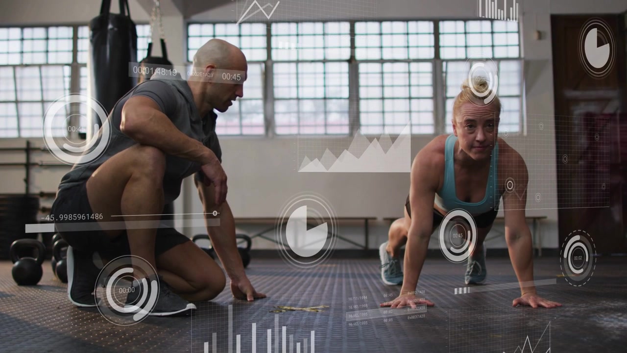 Trainer kneeling cueing trainee performing push-ups in fitness gym, HUD progress bars tracking form