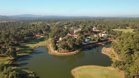 fast flight over a lake in a golf resort and residential area