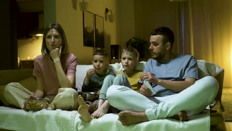 family enjoying movie