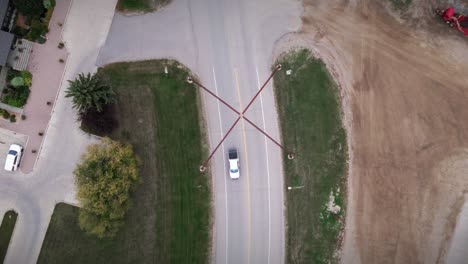 a wide angle drone shot of the northern canadian landscape a small rural town skiing fishing village main street arches in asessippi community in binscarth russell manitoba canada top down road