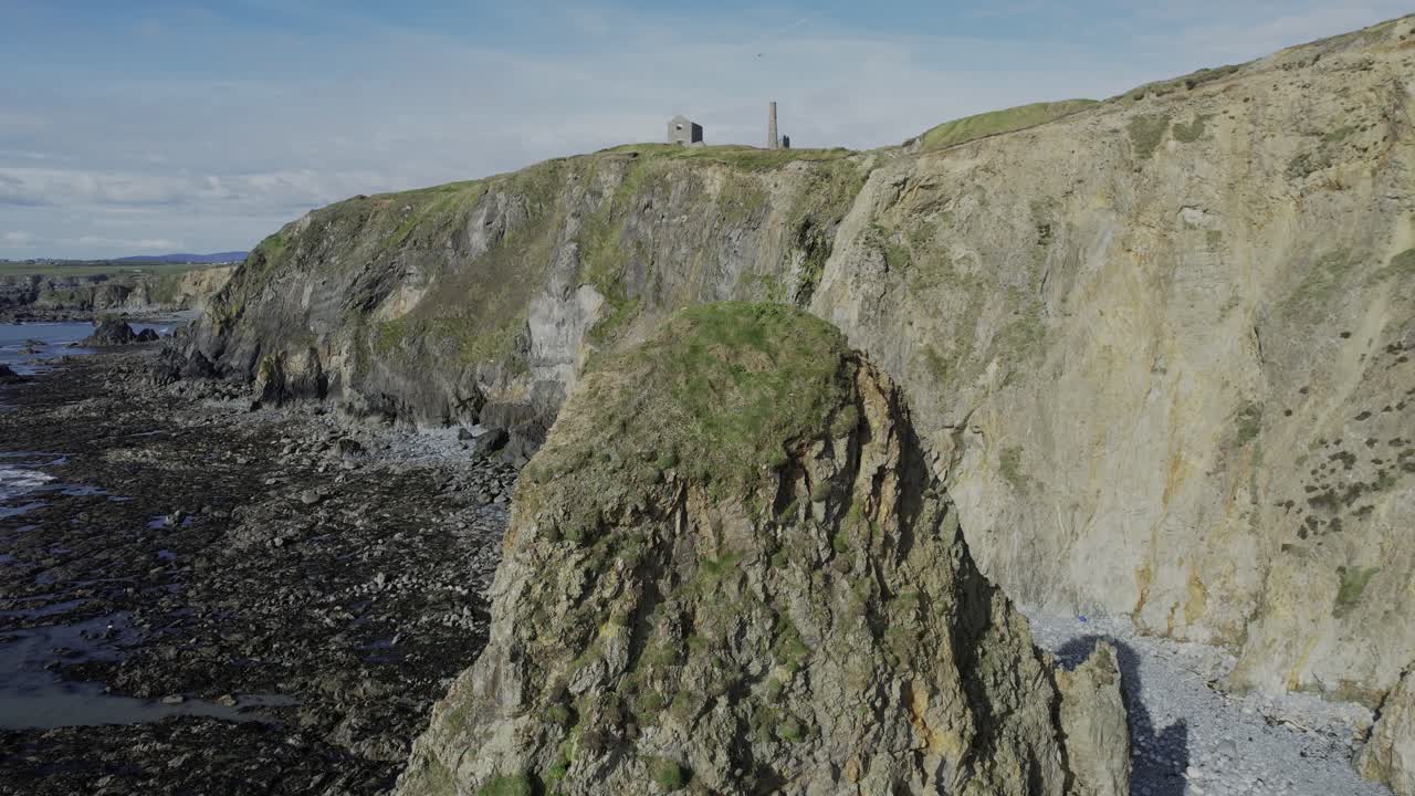 Ireland landscapes Drone rising behind seastack to reveal ruins and landscape of Co. Waterford Ireland epic locations