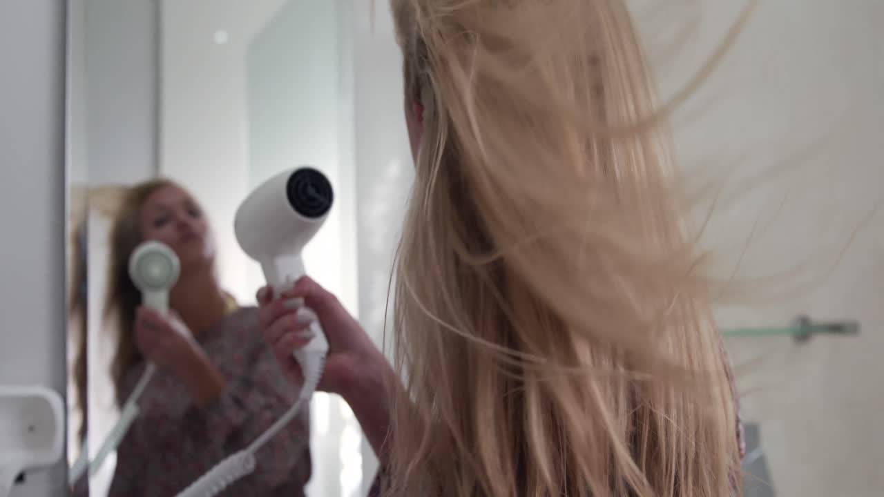 Young woman drying her hair