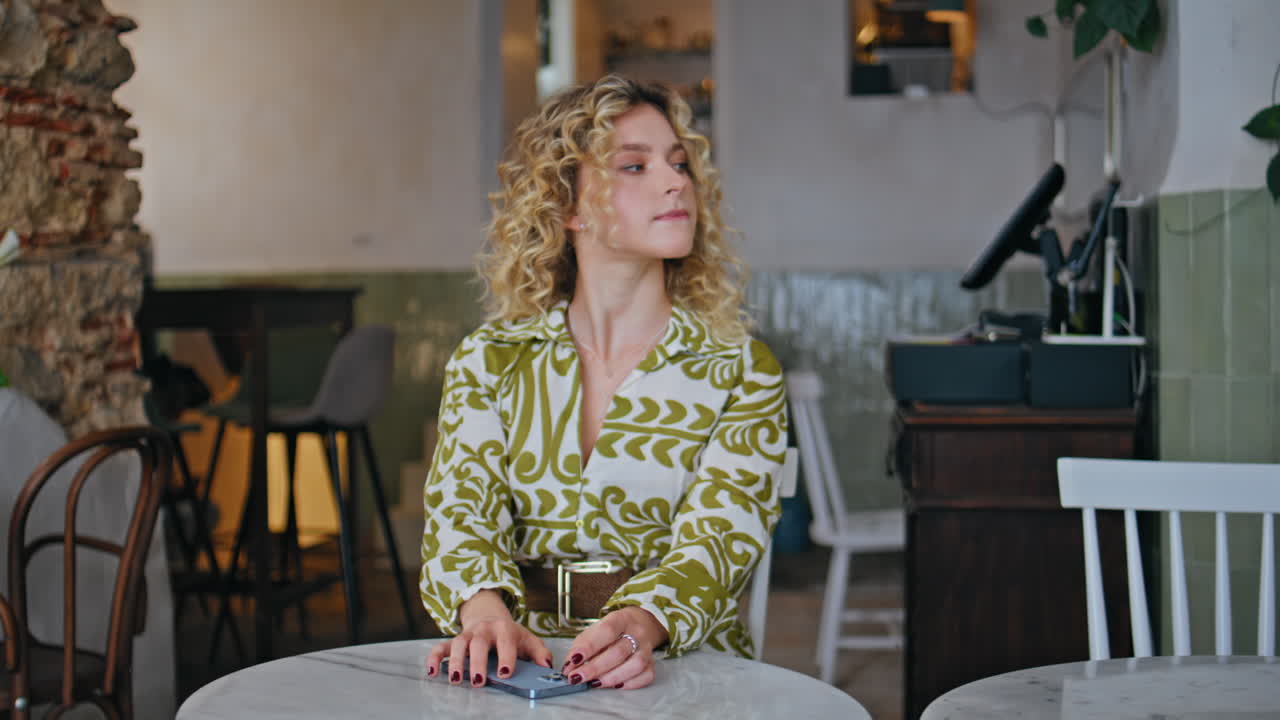 blonde waiting order in modern coffee house closeup. Elegant woman