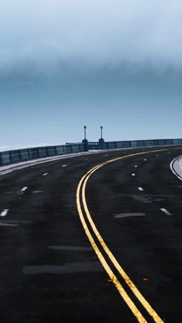 empty road curve on bridge in foggy weather